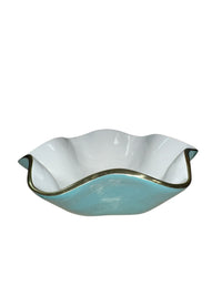 The Encanto Carola Bowl - Small by Beatriz Ball features white and light blue glass with a wavy ruffled edge and metallic trim, shown from the side against a white background.