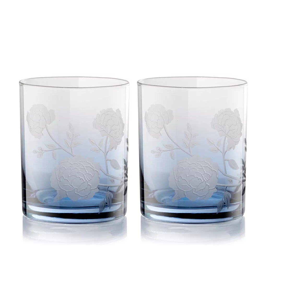 The Peony DOF Set of 2 by Current Home features clear, cylindrical tumblers with etched floral and leaf designs, crafted from mouth-blown glass and shown side by side on a white background.