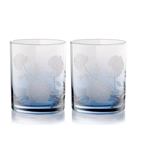 The Peony DOF Set of 2 by Current Home features clear, cylindrical tumblers with etched floral and leaf designs, crafted from mouth-blown glass and shown side by side on a white background.