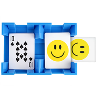 The Canasta Spinner by Canasta Sets is a blue plastic cardholder that holds three cards: the ten of spades and two with large yellow smiley faces, one partially revealed—an ideal accessory for your next canasta game night.