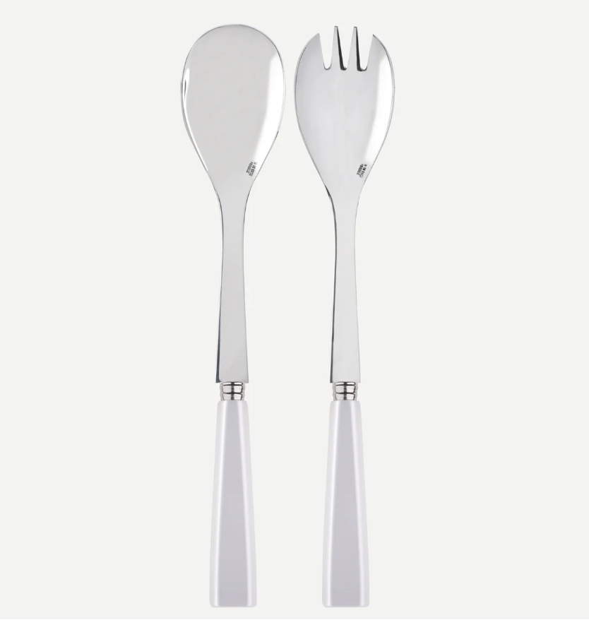 The Sabre Icone Salad Set - White by Sabre features a shiny metal spoon and three-tined fork with white handles, displayed upright side by side on a plain background.