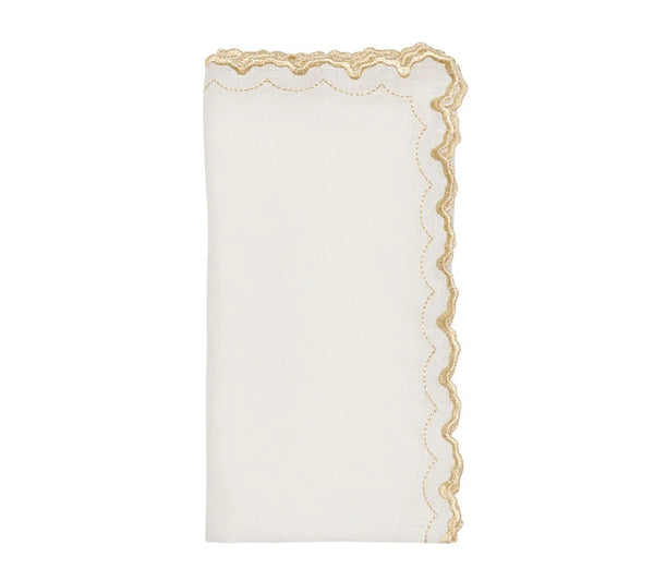 The Arches Napkin Set of 4 by Kim Seybert features folded white linen napkins with scalloped edges, a gold embroidered trim on one side, and a subtle geometric design, shown against a plain white background.