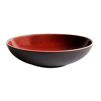 The Tourron Dinnerware Cerise by Jars - Rosenthal is a shallow, round ceramic bowl featuring a dark brown exterior and glossy reddish-brown interior, shown against a white background.