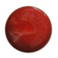 The Tourron Dinnerware Cerise by Jars - Rosenthal is a round ceramic bowl with a vibrant red glaze and crackled texture, offering eye-catching style. Its durable finish is dishwasher safe for easy cleaning.