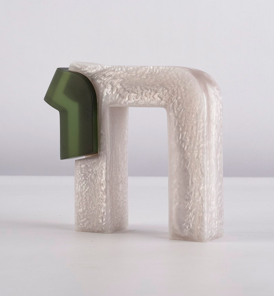 The Chai Sculpture by CDMX / BRUCI is a modern abstract piece handmade in Mexico, showcasing a textured pearly white arch and a smooth dark green geometric form, set against a simple light background.