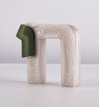 The Chai Sculpture by CDMX / BRUCI is a modern abstract piece handmade in Mexico, showcasing a textured pearly white arch and a smooth dark green geometric form, set against a simple light background.
