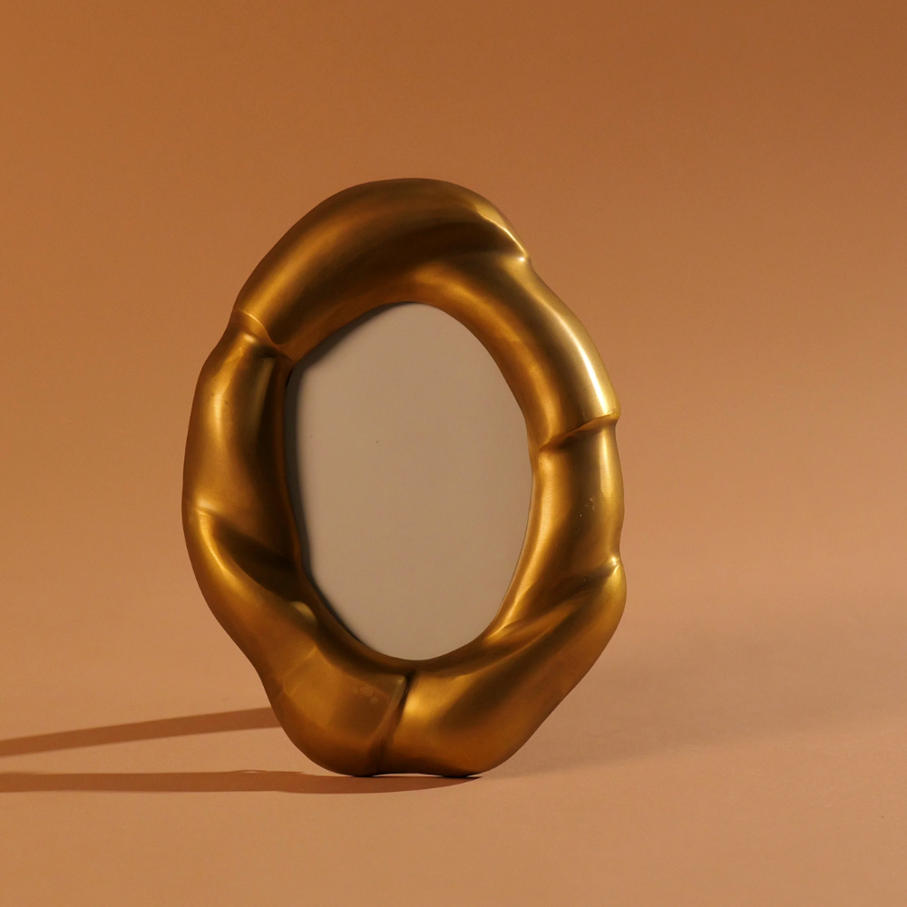 The Julie Oval Frame Brass by Dumae features a sculpted gold finish—an elegant accent and a lasting gift for anyone who appreciates unique picture frames.