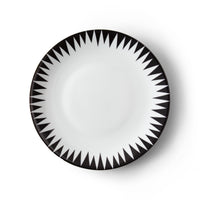 The Punk Dinnerware by Molecot features a round white Limoges porcelain plate with a bold black geometric triangle pattern radiating from the rim, creating a striking starburst effect—an ideal piece of modern tableware.