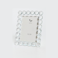 The Tizo Crystal Ball Frame is a luxury home decor piece with round, clear crystals on silver edges. It stands upright and includes a placeholder card for a 5x7 inch photo.