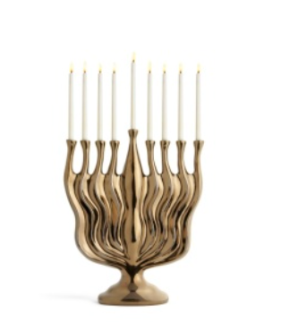 L’Objet Timna Menorah - Bronze: a metallic bronze menorah with a wavy, sculptural base holding nine lit white candles, presented in a luxury gift box.