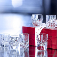 The Baccarat Take A Shot - Les Mini Set includes six elegant mini shot glasses, beautifully displayed on a red gift box with a white ribbon—perfect glassware for gifting.