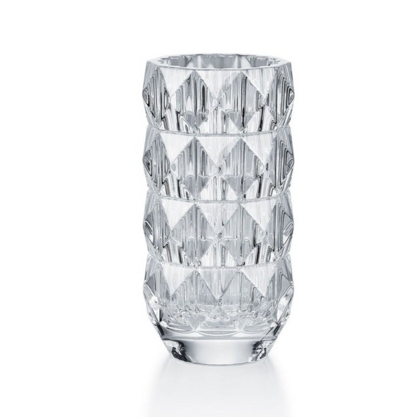The Louxor Round Vase Small by Baccarat is a clear, faceted crystal vase with a geometric pattern and thick base, inspired by Thomas Bastide and designed to reflect light for a sparkling effect.