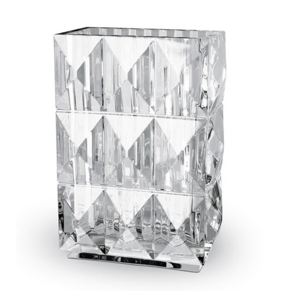 The Louxor Rectangle Vase by Baccarat features clear, faceted crystal in a geometric design, giving its rectangular form a diamond-like texture that makes it a striking luxury decor accent against any white background.