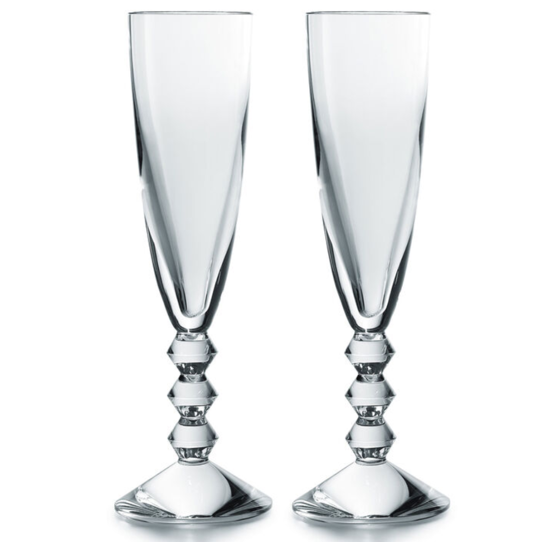 The Baccarat Vega Champagne Flute Set of 2 features clear crystal glasses with tall, faceted stems and geometric detailing—an elegant French-made pair, perfect for gifting in a luxury box.