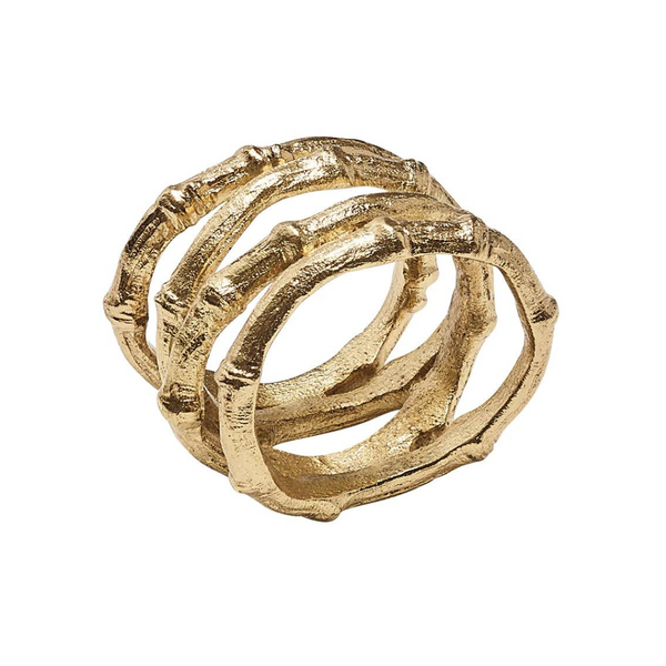 The Kim Seybert Bamboo Napkin Ring Gold Set of 4 features three textured, interwoven bands with a faux bamboo design—an elegant gold accent for your table setting.