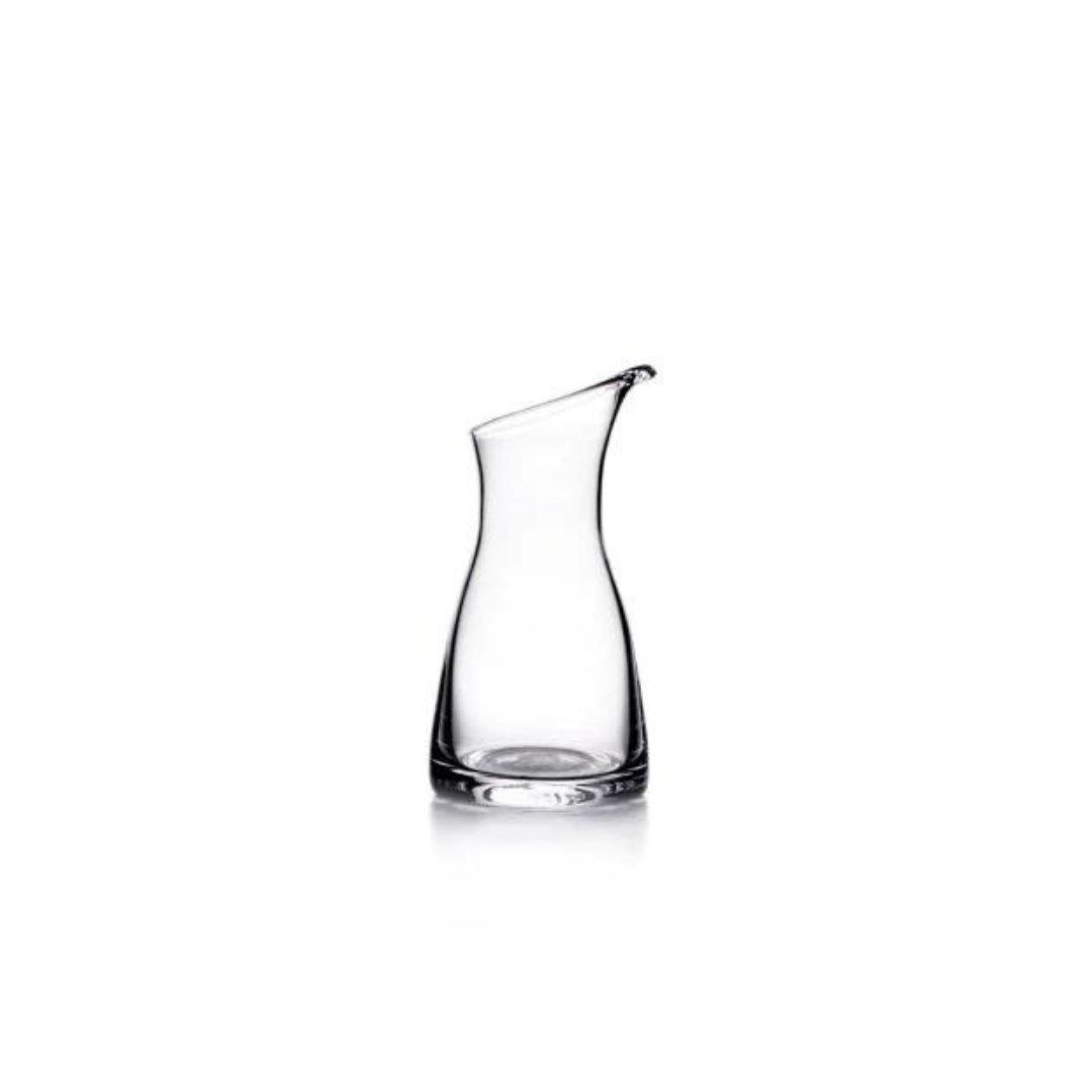 The Simon Pearce Barre Carafe features a slightly tapered neck and curved spout; this modern tabletop pitcher is shown against a white background.