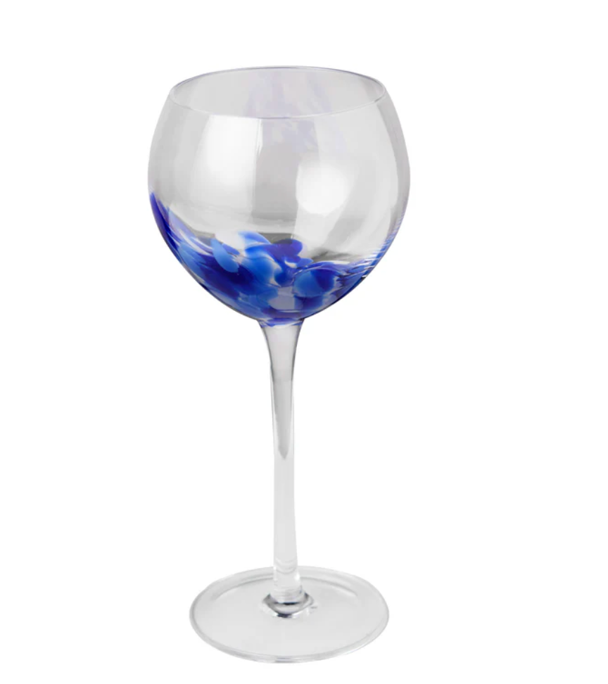 The Abigails Fiesta Wine Glass - Blue & White features a clear, round bowl adorned with blue and white swirl patterns inside the lower part of this handmade glass.