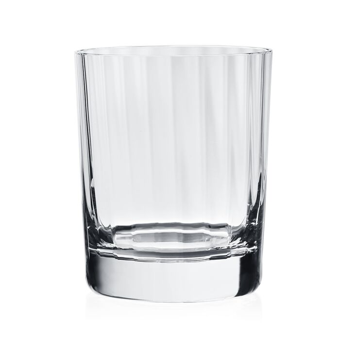 The Corinne Drinkware by William Yeoward is a clear, straight-sided glass tumbler with a thick base, shown empty against a white background—a sleek addition to modern barware collections.