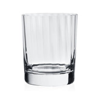The Corinne Drinkware by William Yeoward is a clear, straight-sided glass tumbler with a thick base, shown empty against a white background—a sleek addition to modern barware collections.