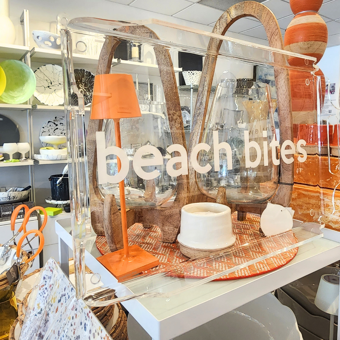 The Eye Candy Deluxe Acrylic Beach Bites Tray sits elegantly among white, orange, and wood-toned kitchenware and ceramics—perfect for stylish outdoor entertaining.