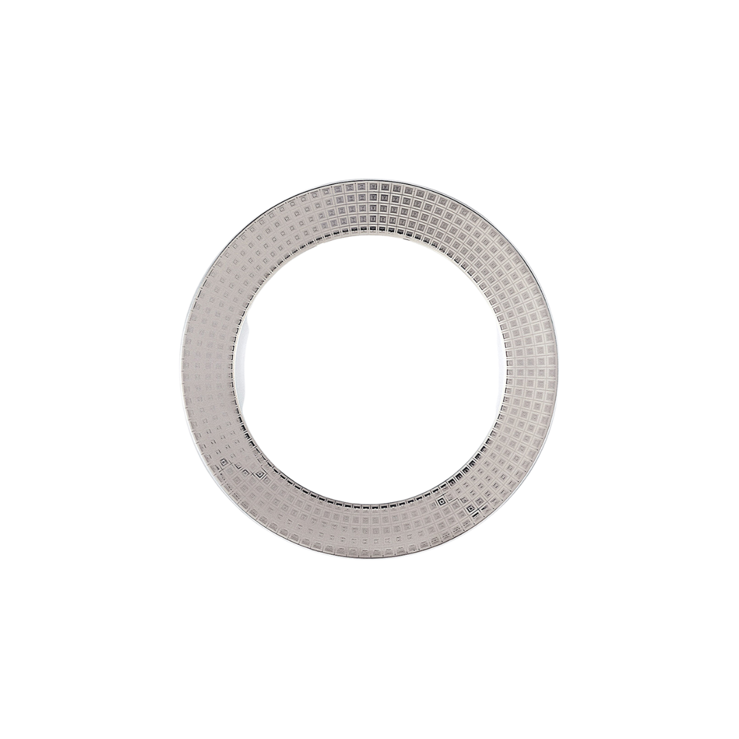 A single metallic circular object with a grid-like pattern and hollow center, inspired by the elegant textures of Bernardaud's Athena Platinum Dinnerware, is displayed against a plain white background.