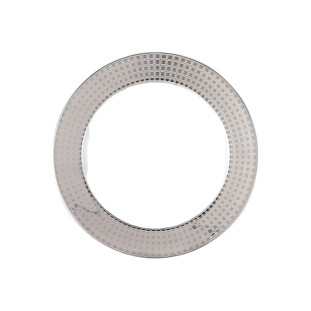Shown from above on a white background, the Athena Platinum Dinnerware by Bernardaud is a round, silver-colored porcelain plate with a grid-patterned rim and plain center.