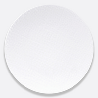 A round, white Bernardaud Organza White Dinnerware plate featuring a subtle textured crisscross pattern, displayed on a plain light gray background.
