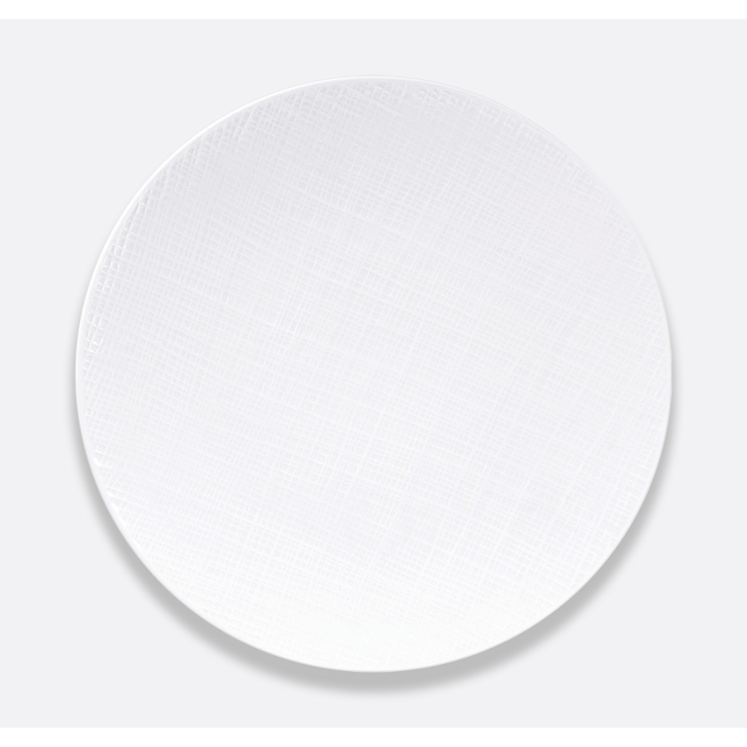 The Bernardaud Organza White Dinnerware is a ceramic dinner plate featuring a textured, woven pattern—perfect for minimalist interior décor.