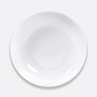 The Bernardaud Organza White Dinnerware plate, crafted from Limoges porcelain with a subtle textured pattern, is shown from above on a light gray background—ideal for complementing minimalist décor.