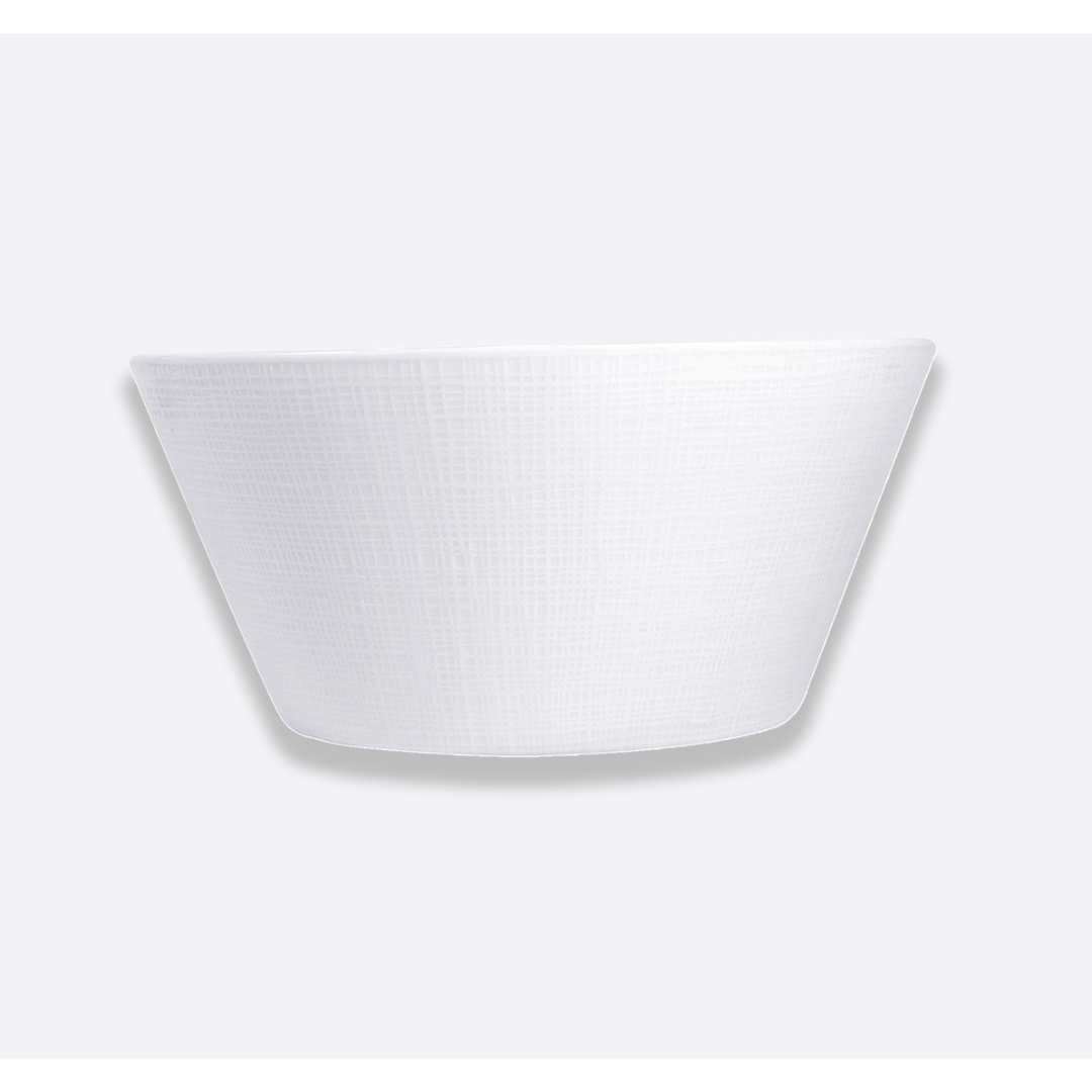 The Organza White Dinnerware by Bernardaud is a white, textured, round bowl with slightly flared sides set against a light gray background—ideal for minimalist interiors.