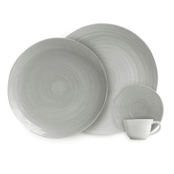 A set of four grey Bernardaud Origine Dinnerware pieces, including two dinner plates, one small plate, and a matching cup—all crafted from Limoges porcelain with a subtle circular textured pattern.