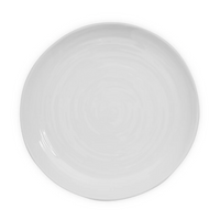 A plain, round white ceramic plate with a slightly uneven rim, viewed from above on a white background—classic Bernardaud Origine Dinnerware White reminiscent of refined Limoges porcelain.