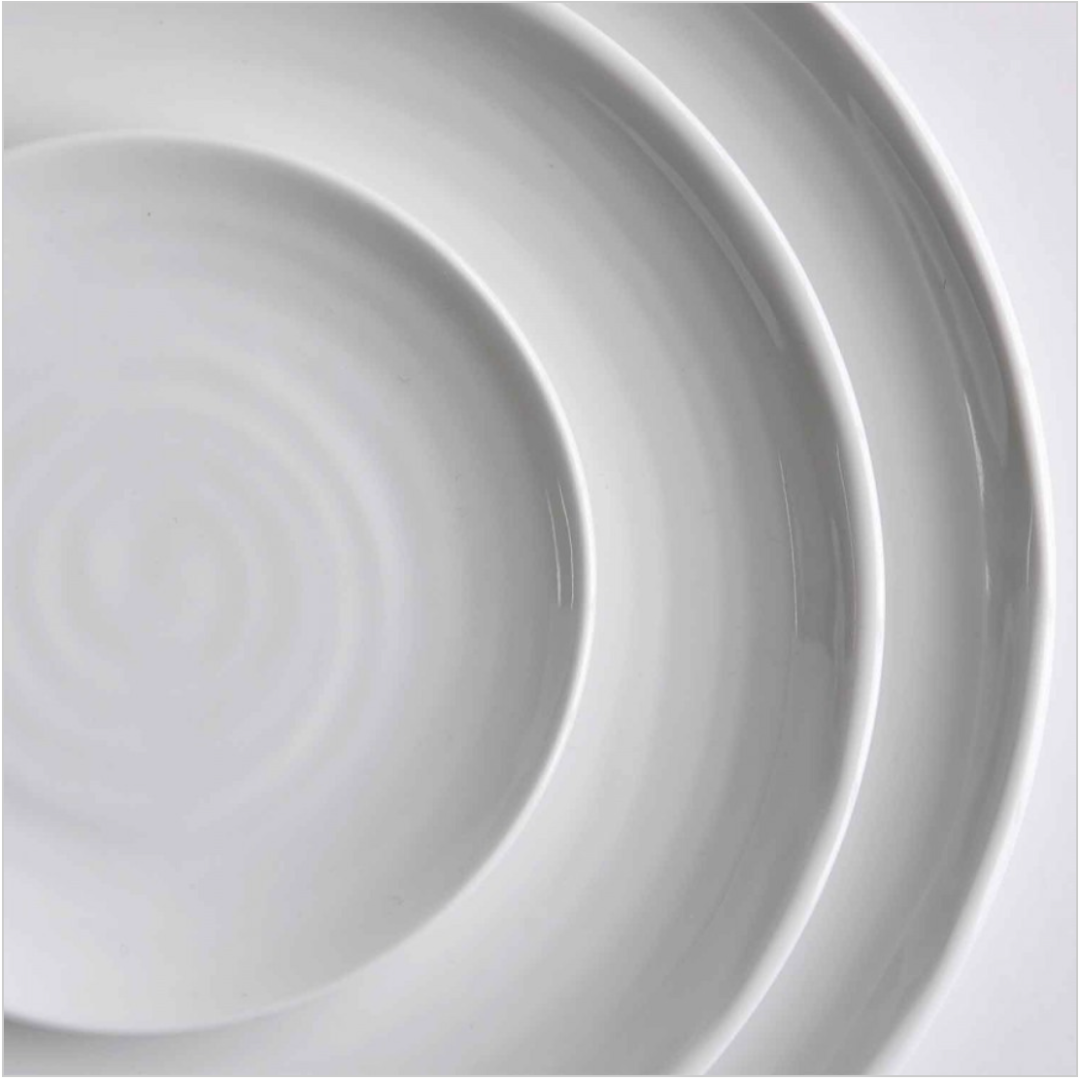 Close-up of three overlapping Origine Dinnerware White plates by Bernardaud, arranged in a circular pattern to showcase their elegant design against a plain background.