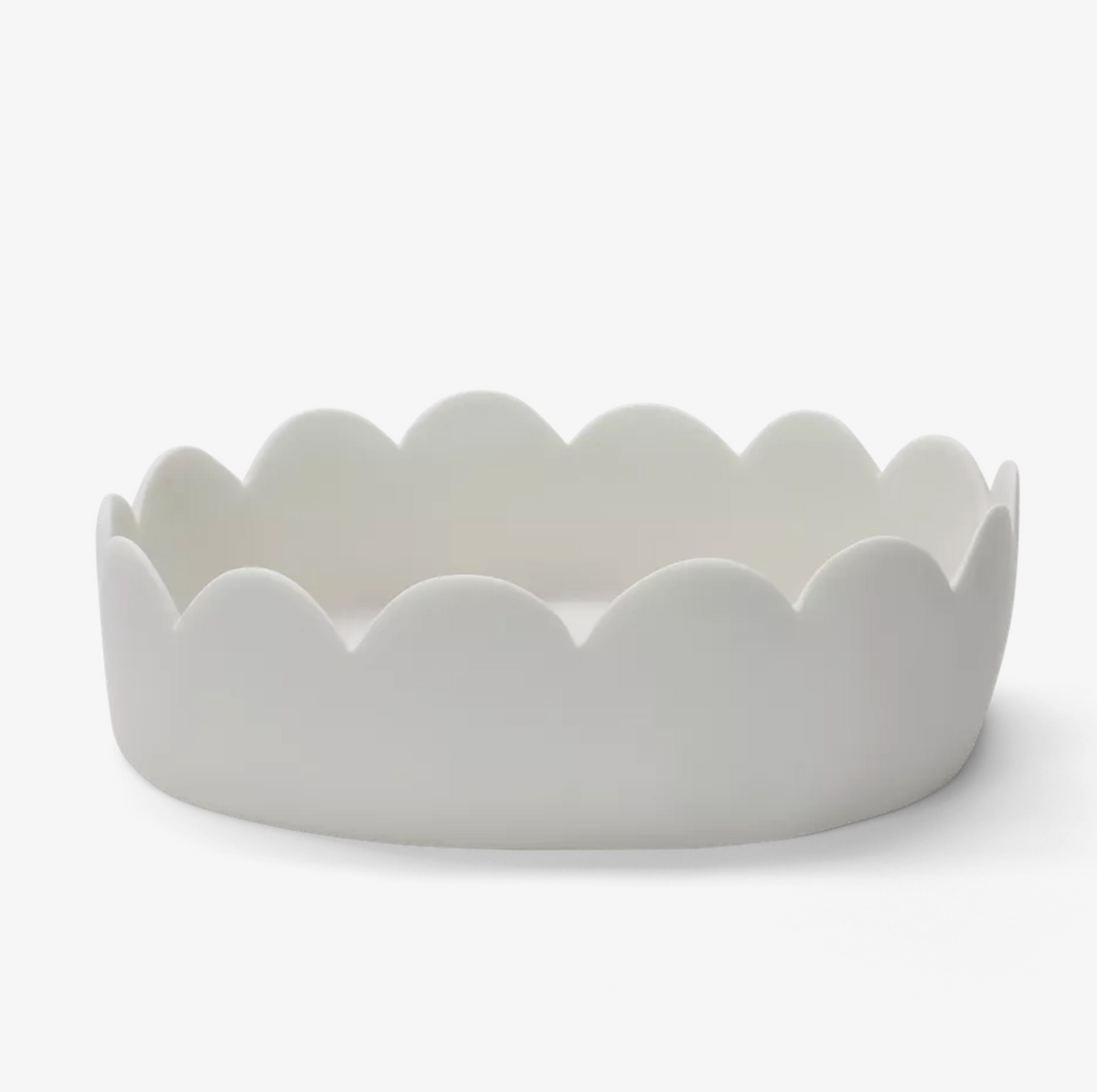 The Tina Frey Fleur Oval Bowl in white, a ceramic baking dish with scalloped, wavy edges, is shown on a plain white background.