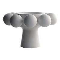 The Nimbus Footed Bowl Alabaster by KleinReid features a modern design with hand-appliquéd porcelain spheres adorning its wide top and round base, all in a sleek alabaster finish.