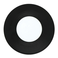 A JL Coquet Hemisphere Dinnerware in Bakelite Black, featuring a sleek black finish and minimalist blank white center, displayed on a white background.