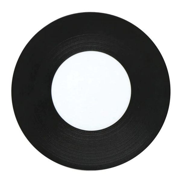 A JL Coquet Hemisphere Dinnerware in Bakelite Black, featuring a sleek black finish and minimalist blank white center, displayed on a white background.