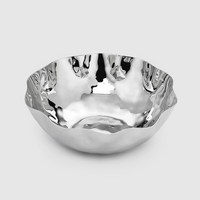 The Mary Jurek Blossom Stainless Steel Bowl, featuring a hammered texture and wavy rim, is displayed on a plain light gray background.