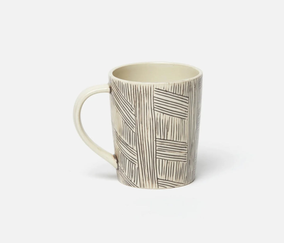 The Blue Pheasant Nolan Dinnerware Black Cream mug, with its cream base and distinctive hand-drawn black geometric lines, sits on a plain white background—a stylish artisanal piece ideal for any stoneware or curated tabletop collection.