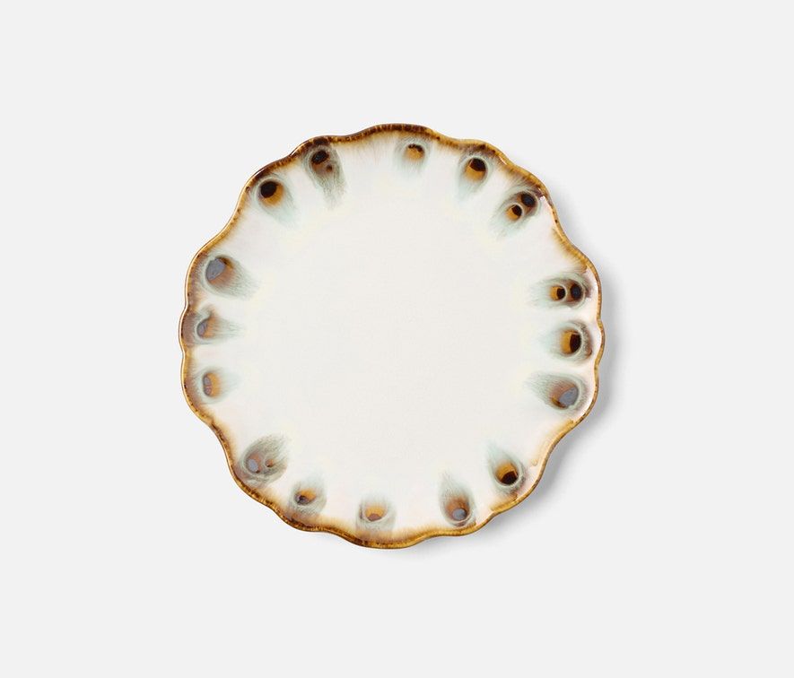 The Amoria Dinnerware by Blue Pheasant features a round ceramic plate with scalloped edges, a white center, and a brown and blue speckled rim, bringing vintage-inspired charm to any light table setting.