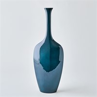 The Silhouette Reactive Vase Blue by Global Views/Surya features a tall, slender ceramic design with a glossy blend of dark and light blue shades and a narrow neck, set against a plain white background.