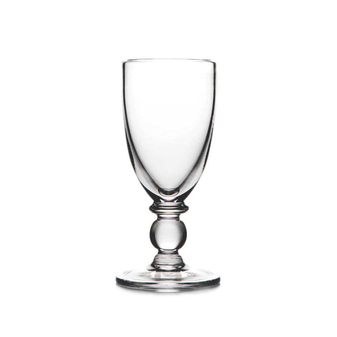 The Hartland Glass champagne flute by Simon Pearce, made from lead-free glass with a rounded stem and wide base, is displayed against a white background.