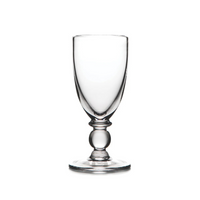 The Hartland Glass champagne flute by Simon Pearce, made from lead-free glass with a rounded stem and wide base, is displayed against a white background.