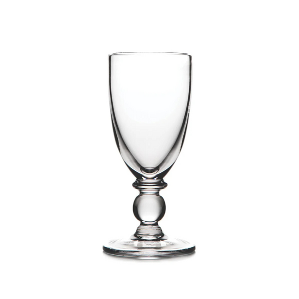 The Hartland Glass champagne flute by Simon Pearce, made from lead-free glass with a rounded stem and wide base, is displayed against a white background.