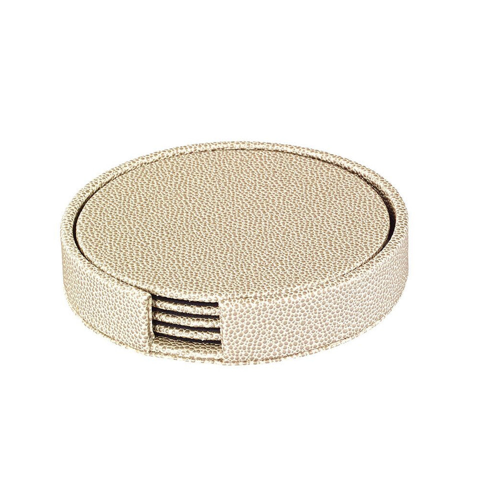 The Bodrum Skate Coaster Set of 4 features round beige textured coasters made from phthalate-free vinyl, neatly stacked in a matching holder with a side opening for easy access.