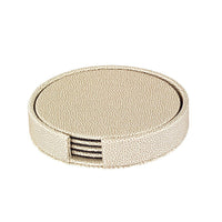 The Bodrum Skate Coaster Set of 4 features round beige textured coasters made from phthalate-free vinyl, neatly stacked in a matching holder with a side opening for easy access.