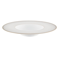 The Oskar Dinnerware by Raynaud is a white Limoges porcelain plate with a wide, shallow bowl, subtle textured rim pattern, and a thin gold border around the edge.