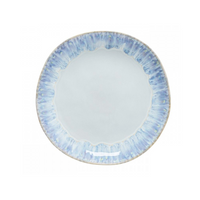 The Costa Nova Brisa Blue Dinnerware plate features a round stoneware design with a light blue and white marbled rim and smooth pale center, crafted in Portugal as part of the Brisa Blue Dinnerware collection.