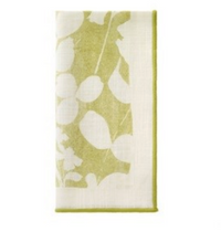 The Bodrum Fleur de Lin Napkin s/4 - Green features a folded white cotton design with a green botanical leaf pattern and matching border, ideal for pairing with floral table linens or a coordinating table runner.