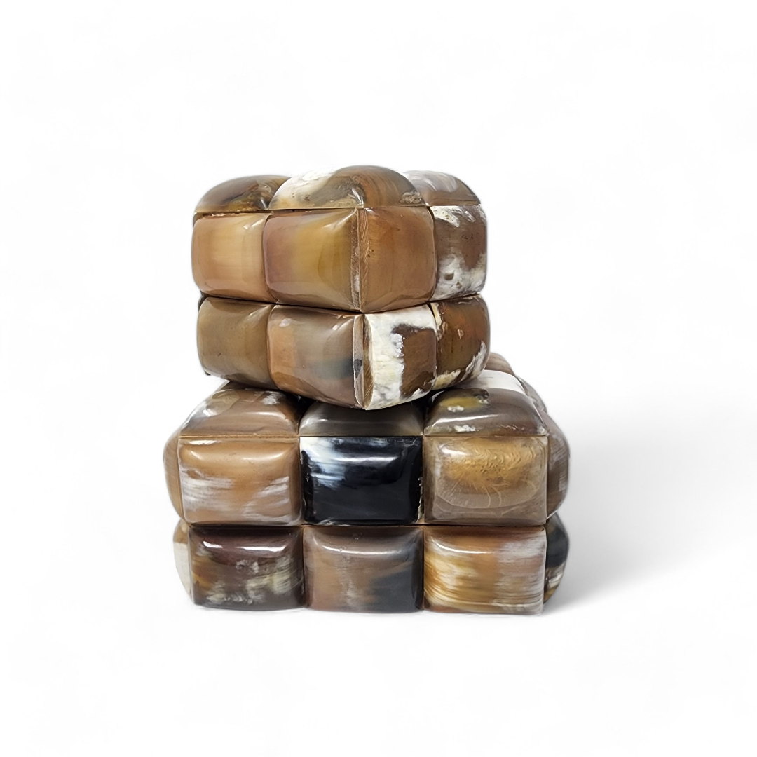 Two stacked Bubble Horn Boxes by A Sanoma Inc are shown on a white background. These cube-shaped decor pieces feature smooth, polished brown and beige marbled surfaces, each composed of smaller rounded square segments joined together.